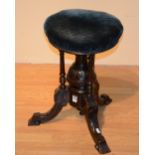 A Victorian mahogany revolving piano stool, with velour upholstered top,