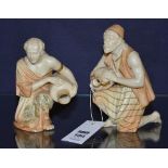 Two Royal Worcester figures of water carriers, in the form of a male and female,