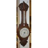 An Edwardian oak 'Banjo' aneroid wall barometer by Dobbie Mcinnes Ltd,
