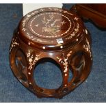 A Chinese rosewood and mother of pearl jardiniere stand, of barrel shape,