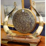 A vintage horn mounted table gong, with brass gong and beater, raised on oak plinth base,