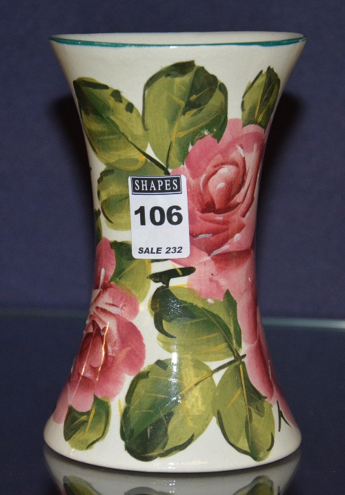 A Wemyss flared pottery vase, decorated with hand painted pink roses with green leaves,