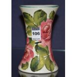 A Wemyss flared pottery vase, decorated with hand painted pink roses with green leaves,