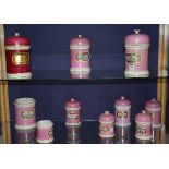 Ten pink and red glazed pottery chemist jars, circa 19th century, graduated sizes,