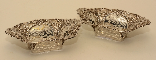 A pair of silver bon-bon dishes, hallmarks for Birmingham 1908, with embossed foliate decoration,