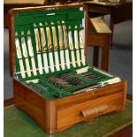A canteen of plated cutlery with bone handles in fitted walnut case,
