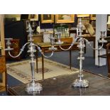 A pair of tall plated candelabra, the two scrolling branches with sconces,