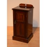 A late Victorian mahogany bedside locker, with panelled door above plinth base,