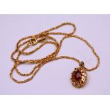 A 9ct gold ruby and diamond cluster pendant,