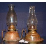 A pair of vintage copper oil lamps, with glass funnels,