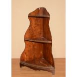 A yew wood corner what-not, the three tiers with gilt metal gallery rails,