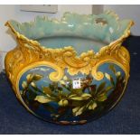 A large Art pottery jardiniere/planter, decorated with floral panel flowers on blue ground,