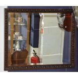 A carved oak wall mirror,