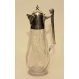 A Silver mounted claret jug with hallmarks for Sheffield 1920, with embossed mask spout,