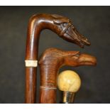 Three walking sticks, one with carved wood horses head, carved eagles head,