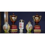 A pair of early 20th century Vienna porcelain garniture vases with covers, in the form of urns,