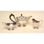 A silver three piece tea set, hallmarks for Birmingham 1928, comprising of teapot, sugar and cream,