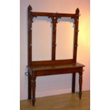 A late Victorian mahogany hallstand, with gilt metal and ceramic pegs,