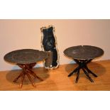 Two Eastern folding occasional tables, with circular tin top, raised on wooden stand ,