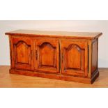 A Spanish cherry wood sideboard, with three panelled doors enclosing shelved interior,