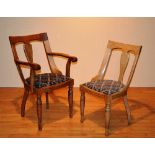 A set of eight oak dining chairs, with splat back and scroll arm rests, raised on turned supports,