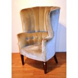 A velour upholstered high back armchair,