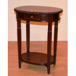 A reproduction two tier occasional table, with drawer and pie crust decoration,