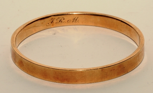 A 9ct gold bangle, inscribed with initials 'JRM' to inside, stamped 9ct, 6.5cm diameter, 12. - Image 2 of 2