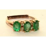 A 14ct gold emerald and diamond ring, with three oval cut emeralds (approx 1.