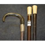 Two ivory topped walking sticks, 91cm long, also with silver collared walking stick,