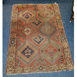 An Eastern rug, the central blue multiple diamonds over red ground,