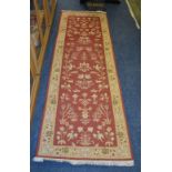 An Eastern style runner, the cream bird end floral design over red ground,