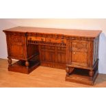 A Victorian oak breakfront sideboard, with two small drawers above carved balustrade,