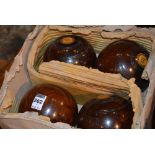 A set of four vintage 'Lignum Vitae' bowling balls, circa late 19th/early 20th century,