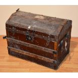 A vintage wood bound travel trunk, the hinged top enclosing fitted interior,