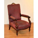 A Victorian French mahogany armchair, with gilt metal decoration to the top, scroll supports,