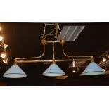 A brass coated ceiling light, with three painted glass shades and chain attachment,