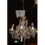 A cut glass ceiling light, decorated with pear shaped drops and pans,