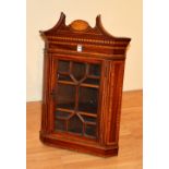 An Edwardian mahogany inlaid hanging corner cabinet,