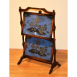 A vintage oak folding two tier occasional table, decorated with embroidered chinoiserie panels,