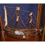 A model tallship, the wooden base with sails and rigging,