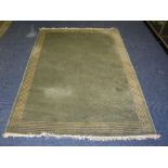 A green Chinese style carpet by John Lewis, of plain design with cream lined border,