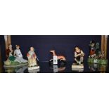 A collection of Staffordshire figures, circa 19th century, to include a gentleman cobbler and wife,