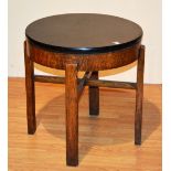 A vintage circular oak coffee table, with ebonised formica style top,