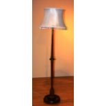 A mahogany floor lamp with shade,