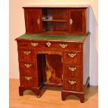 An 18th century walnut inlaid kneehole desk, the superstructure to the top with open shelves,