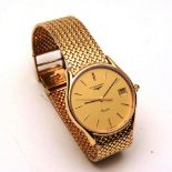 A 9ct gold Longines dress watch, the gold coloured face with baton numerals and date aperture,