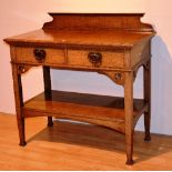 An Arts & Crafts oak serving table retailed by John Taylor & Sons Edinburgh, label to interior,