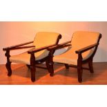 A pair of Chinese type stained wood recliner armchairs, upholstered in yellow floral fabric,