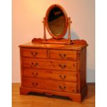 A modern pine chest of drawers, with two small drawers above three long drawers,